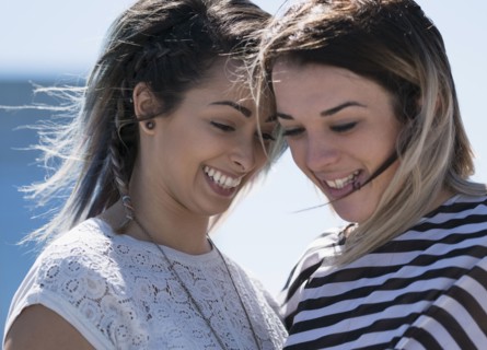 Smiling young women looking down.