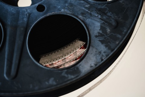 Close-up of film reel on white background.