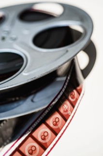 Close-up of film reel on white background.