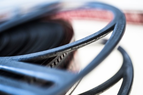Close-up of film reel on white background.