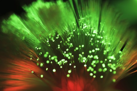Bunch of glowing red and green fiber optic cables.