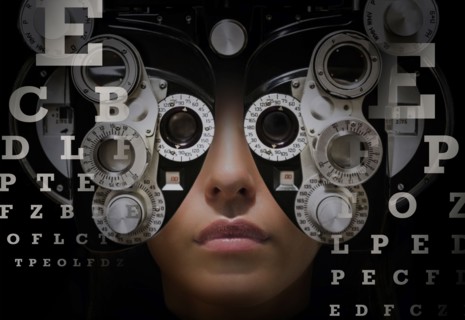 Woman looking through phoropter.