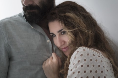 Mid-adult couple hugging.