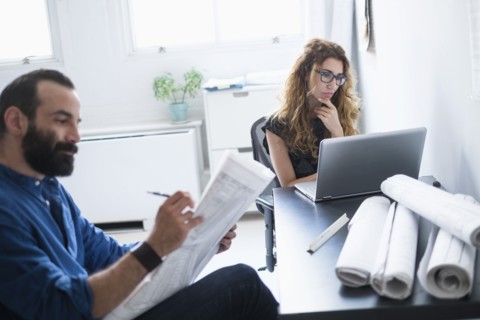 Man and woman working together in office.