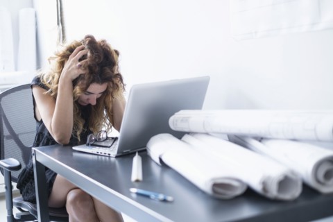 Upset woman in office.