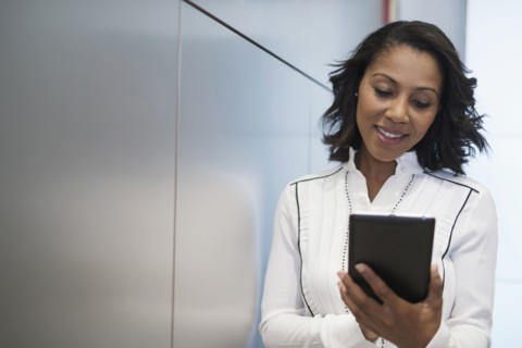 Portrait of woman holding digital tablet.