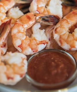 Shrimps and cocktail sauce in bowl