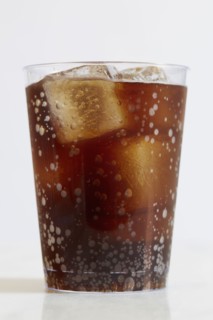 Studio shot of cold drink with ice cubes on white background