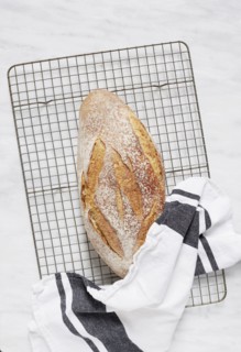 Overhead view of fresh rye bread and dishcloth