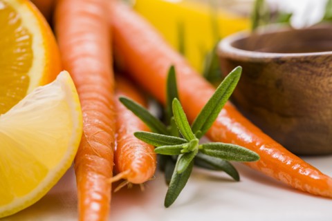 Carrots and oranges with fresh herb