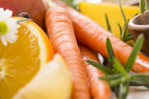 Slice of orange with carrots and fresh herbs