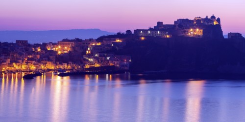 Italy, Campania, Naples, Panorama of Procida Island at sunrise