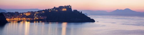 Italy, Campania, Panorama of Procida Island with Mt Vesuvius at sunrise