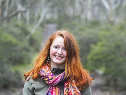 Portrait of smiling redhead woman in scarf