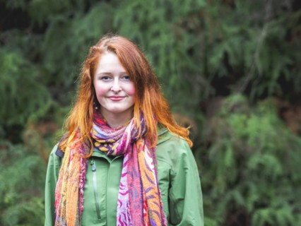Portrait of smiling redhead in scarf and green jacket