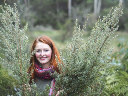 Portrait of smiling redhead in bushes