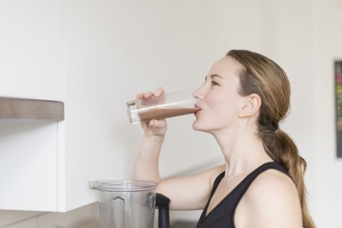 Mid-adult woman drinking smoothie