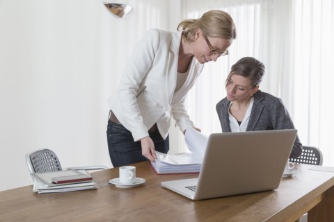 Businesswomen looking at documents at office
