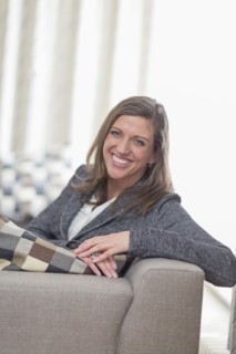 Smiling woman sitting on sofa