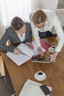 Businesswomen working with tablet and documents