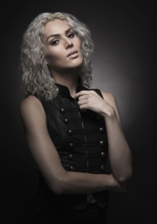 Studio portrait of young woman with white hair.