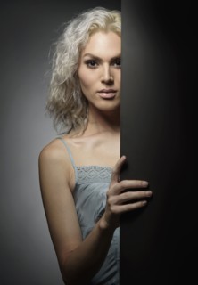 Studio portrait of young woman with white hair.