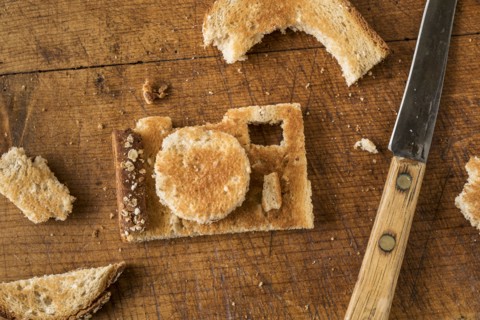 Camera shaped toast bread on cutting board.