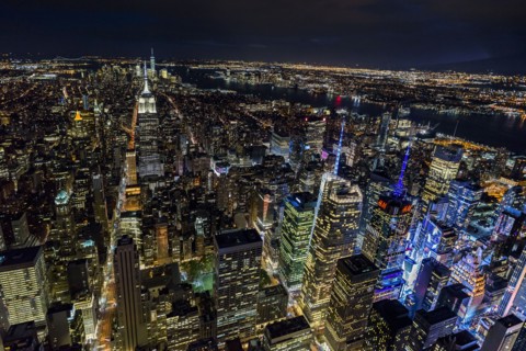 USA, New York, New York City, Manhattan, Aerial view of illuminated skyline at night.