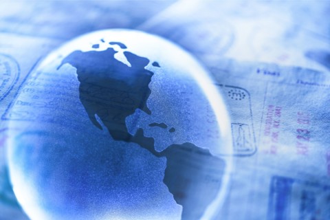Stamps in passport and Planet Earth.