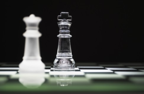 Chess queen and king on chess board.