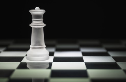 Chess queen on chess board.