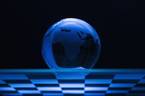 Globe on chess board.