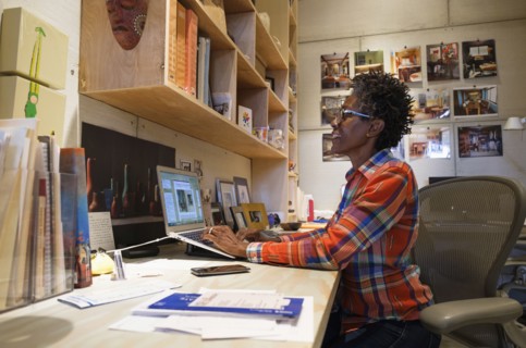 Woman using laptop in office.