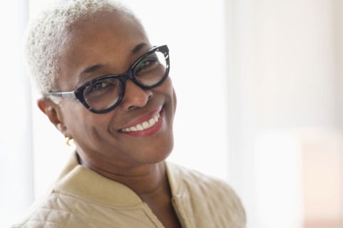 Portrait of smiling woman looking at camera.