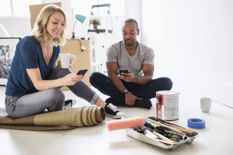 Couple taking break during apartment renovation.