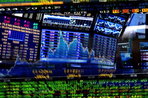 Financial figures on screens.
