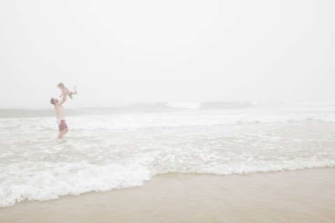 USA, New York, Monatuk, Father and daughter (2-3) on beach by ocean