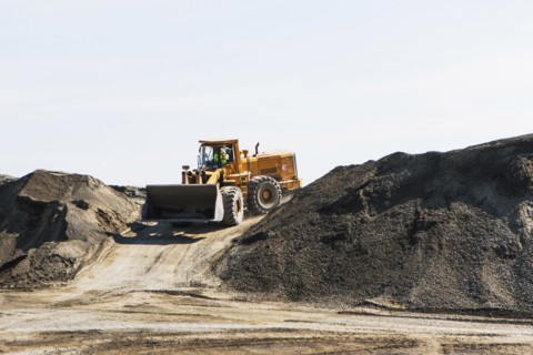 Bulldozer on gravel mound