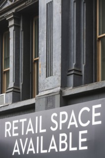 Close-up view of building facade with rental sign