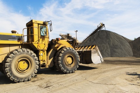 Bulldozer and heap of gravel