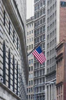 USA, New York State, New York City, Manhattan, Wall Street, American flag among skyscrapers