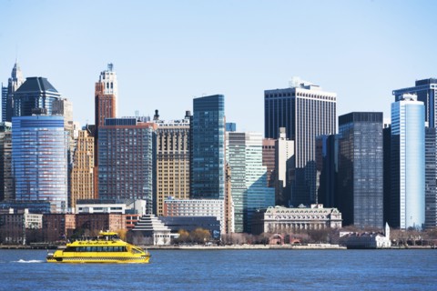 USA, New York State, New York City, Manhattan, City panorama with water taxi passing by