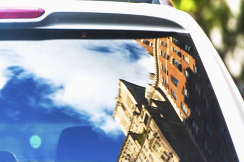 USA, New York State, New York City, Townhouses reflecting in car rear window