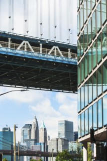 USA, New York State, New York City, City panorama with part of Brooklyn Bridge and skyscraper's facade in foreground