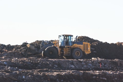 USA, New York State, New York City, Bulldozer on garbage dump