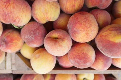Peaches in wooden crate
