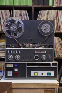 Collection of vinyl LP records and tape recorder