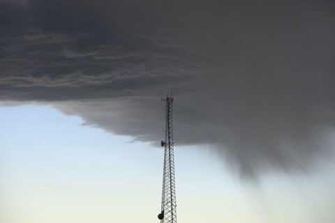 Storm clouds gathering above communications tower