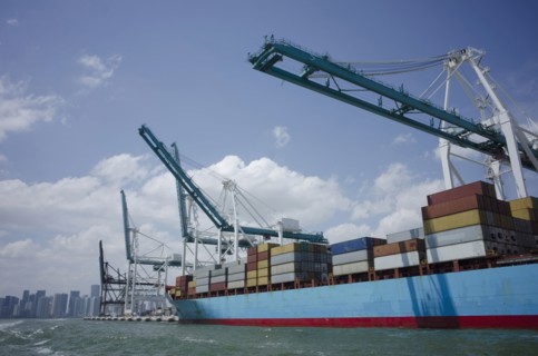 USA, Florida, Miami, Container ship with cranes and city skyline in background