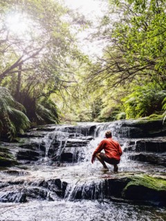 Australia, New South Wales, Katoomba, Man wading in Leura Cascade